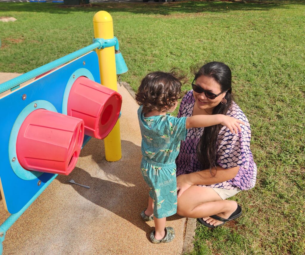 Pua'ena Vierra plays with her son at a park in Pearl City. Vierra and her wife earn too much to qualify for federal assistance but little enough that they still struggle financially.