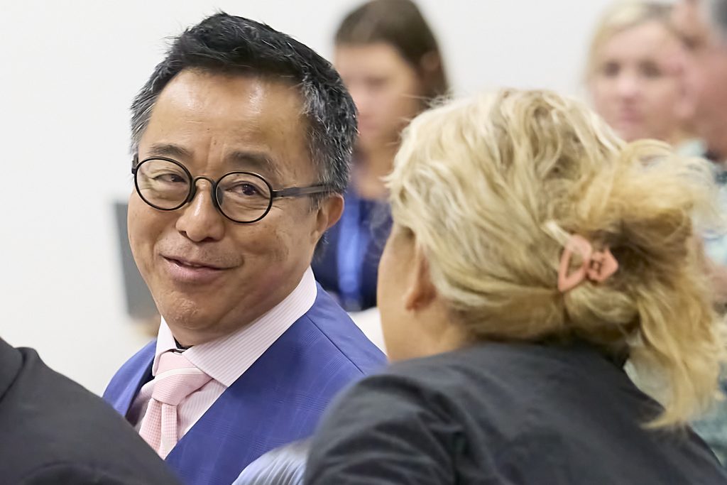 Glenn Wakai chats with Lynne DeCoite, before a committee hear for the financing of Bills 
(David Croxford/Civil Beat/2024)