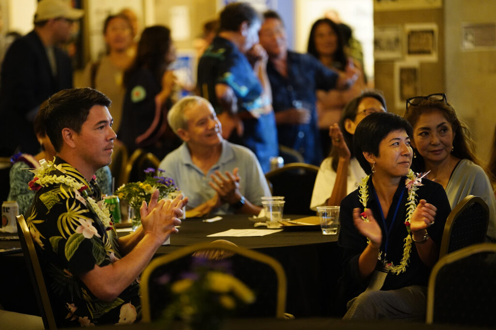 Hawaii State Reps. Sean Quinlan, left, and Linda Ichiyama applaud the opening of the Democrats election night watch party Tuesday, Nov. 5, 2024, in Honolulu. (Kevin Fujii/Civil Beat/2024)