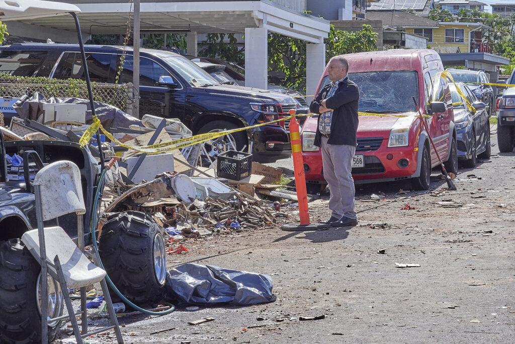 The tragic toll of illegal aerial fireworks shown at the site of 4144 Keaka Drive.  Gov. Josh Green toured the area with Police and other personnel on New Years morning and held an impromptu press conference at the scene confirming that two people had died at the scene with multiple others being transported to local hospitals and two of those, including a child, in life threatening situations.(David Croxford/Civil Beat/2024)