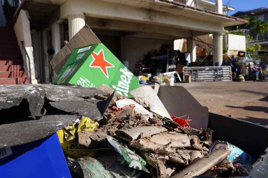 Empty fireworks shell casings and beer containers are photographed in the rubbish of a home where a deadly, New Year’s Eve fireworks explosion took place Thursday, Jan. 2, 2025, in Honolulu’s Salt Lake neighborhood. Multiple fatalities and injuries were reported. (Kevin Fujii/Civil Beat/2025)