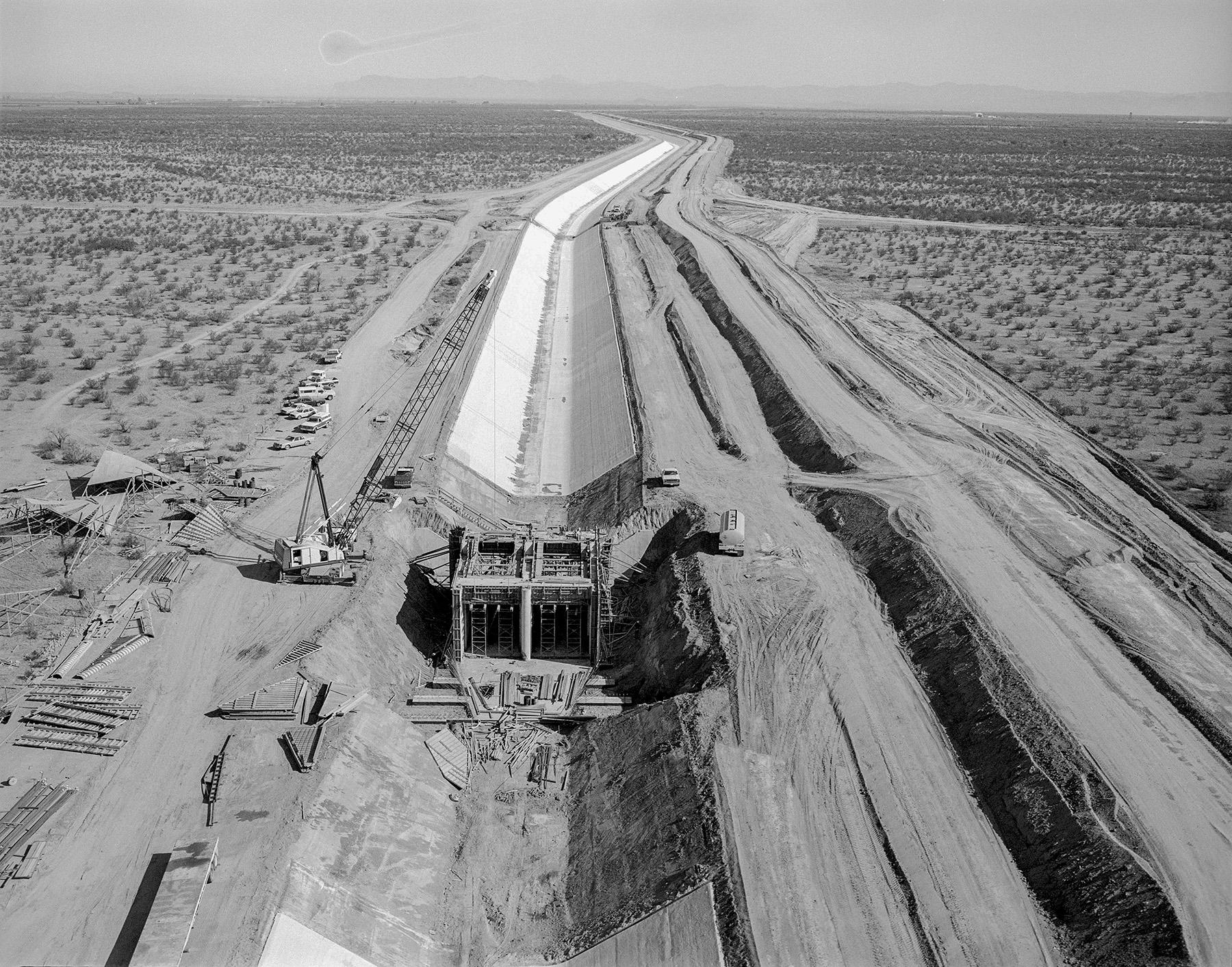 picture shows the construction of an underground water canal in a desert 