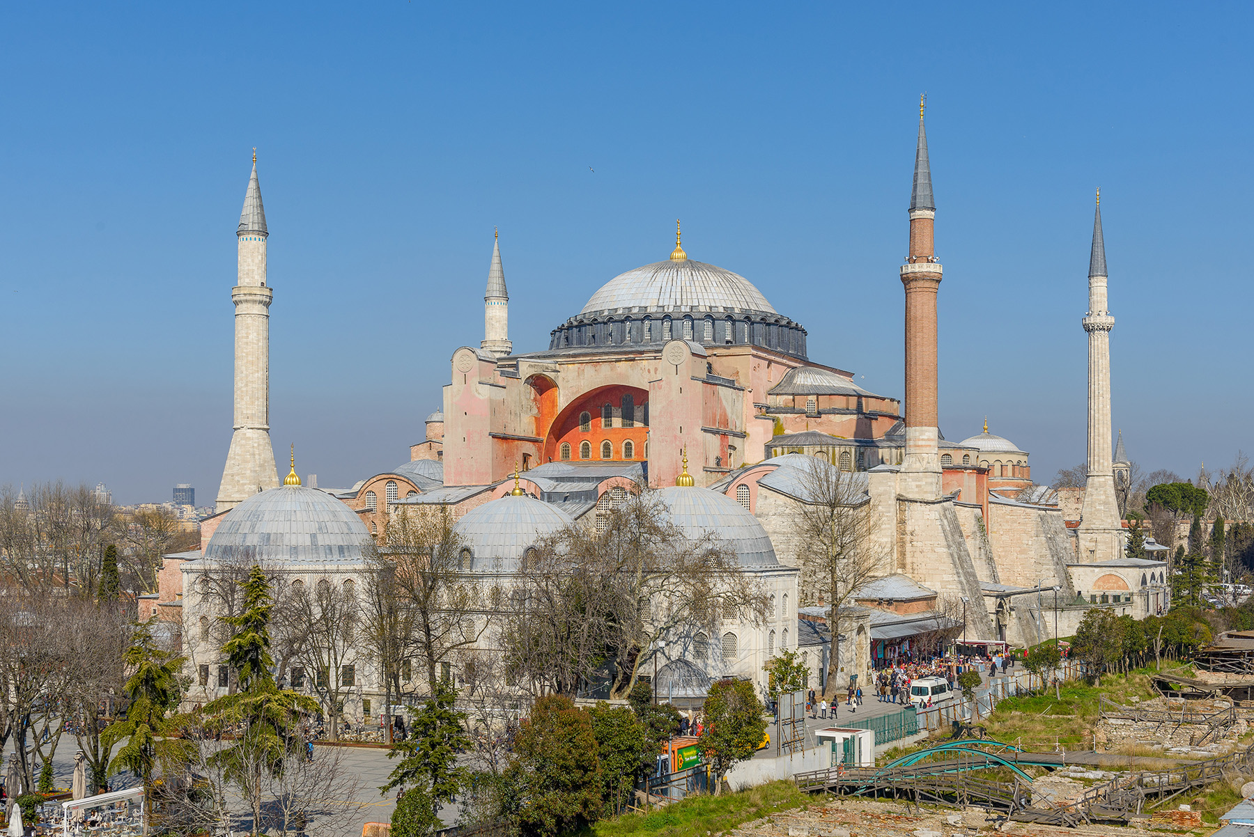 large square structure with multiple domes and columns topped. The building is capped by a large gold dome