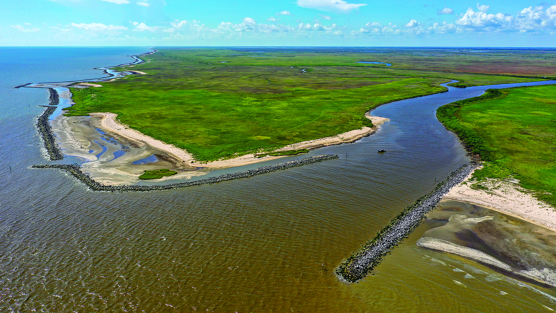 rock barrier between the ocean and smaller body of water and land mass