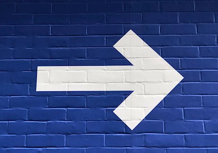 white arrow pointing right on a blue background