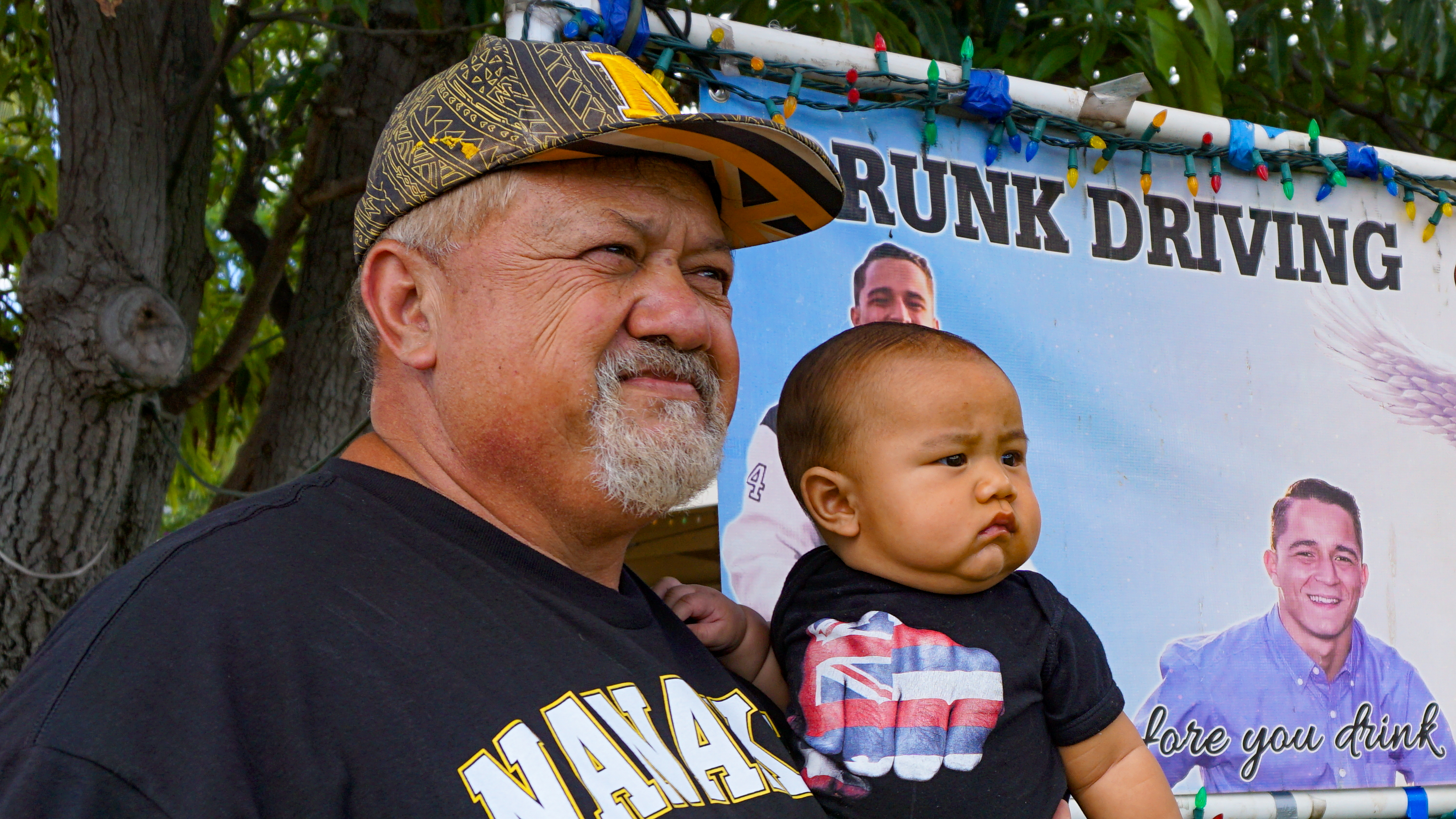 A close-up of Ed Werner with his grandson, Luxe Matthew, outside of his Nanakuli Home.