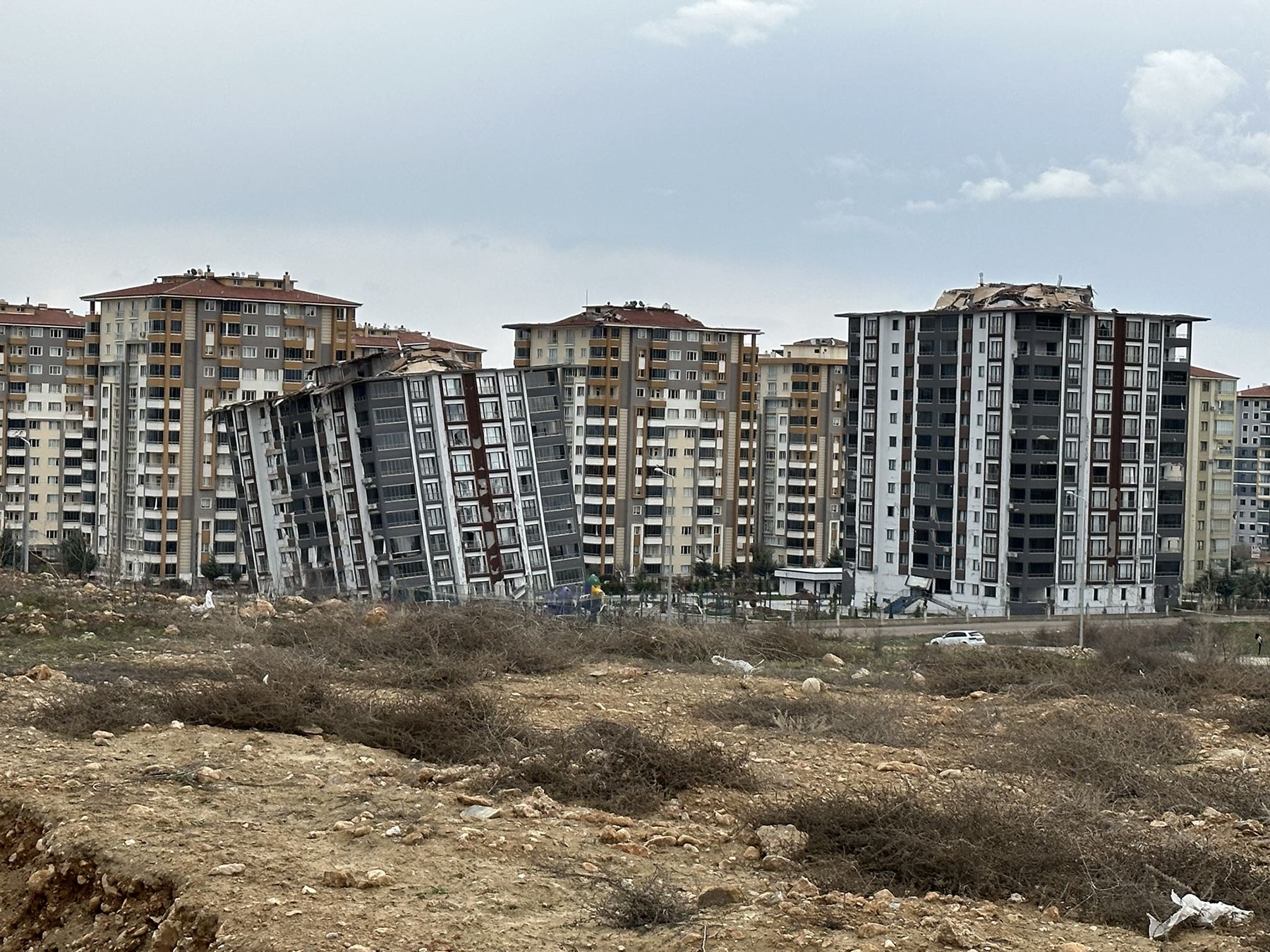 The Earthquake Engineering Research Institute's Buildings Reconnaissance Team regularly noted similar buildings in the same vicinity that fared differently in the earthquakes. Here, in the town of Malatya, Turkey, one of two high-rise apartment buildings collapsed, while the other remained standing. (Image courtesy of Halil Sezen)