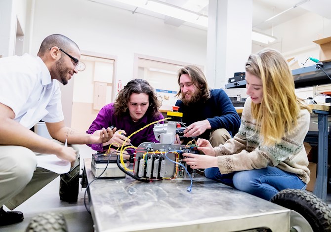 An ASCE Younger Member collaborating with civil engineering students.