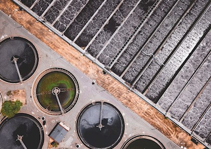 aerial view of a wastewater facility highlighting the geometric elements of the circles and rectangles on the site