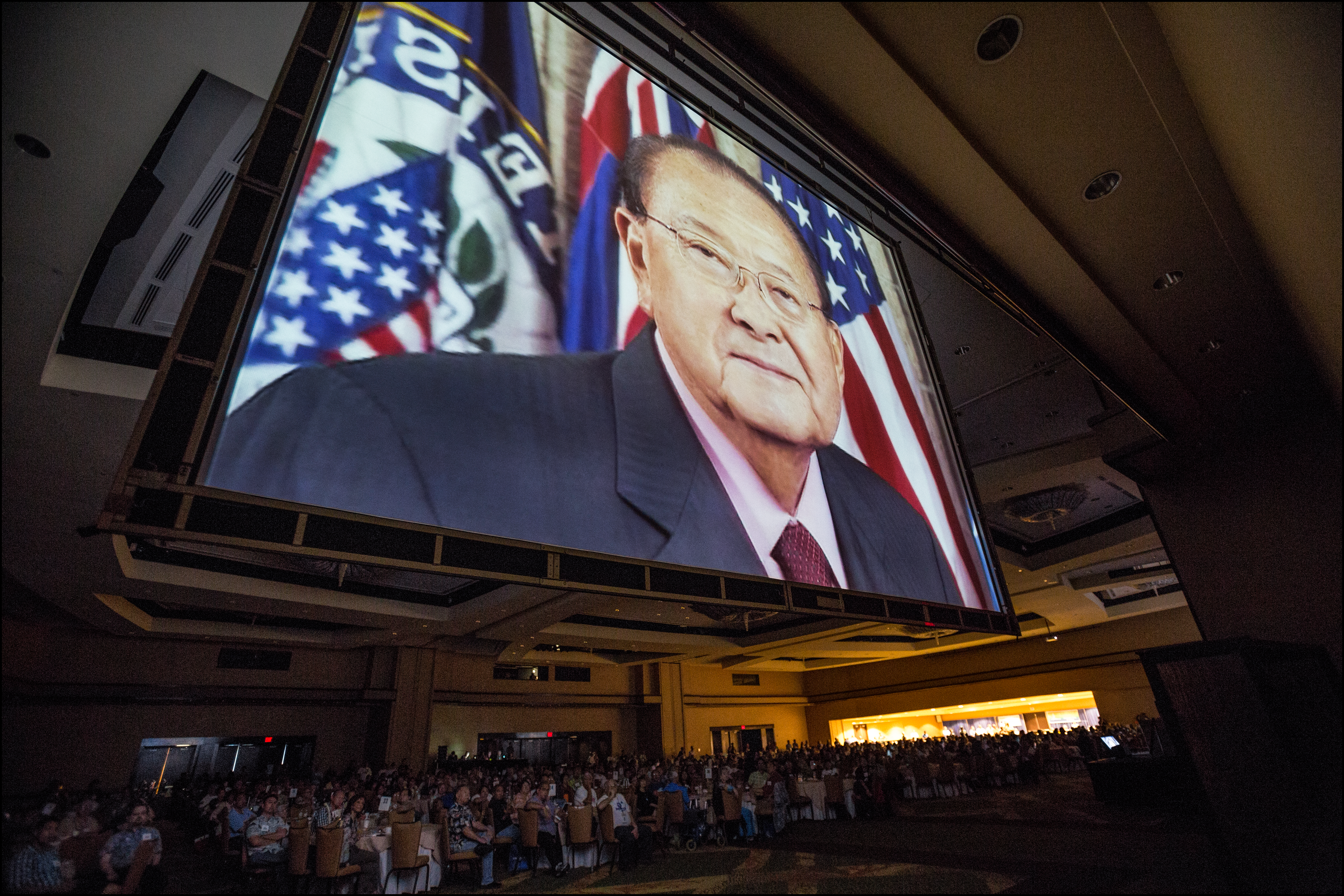 The image of the late Sen. Dan Inouye in a tribute film looms over delegates to open of the second day of the Democratic Party of Hawaii State Convention. 5.25.14©PF Bentley/Civil Beat