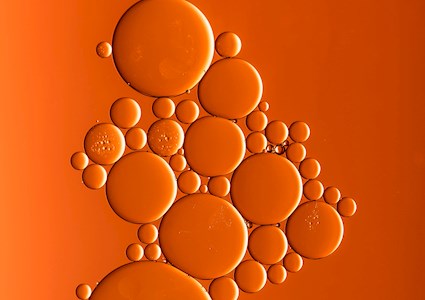 BUBBLES AGAINST ORANGE BACKGROUND