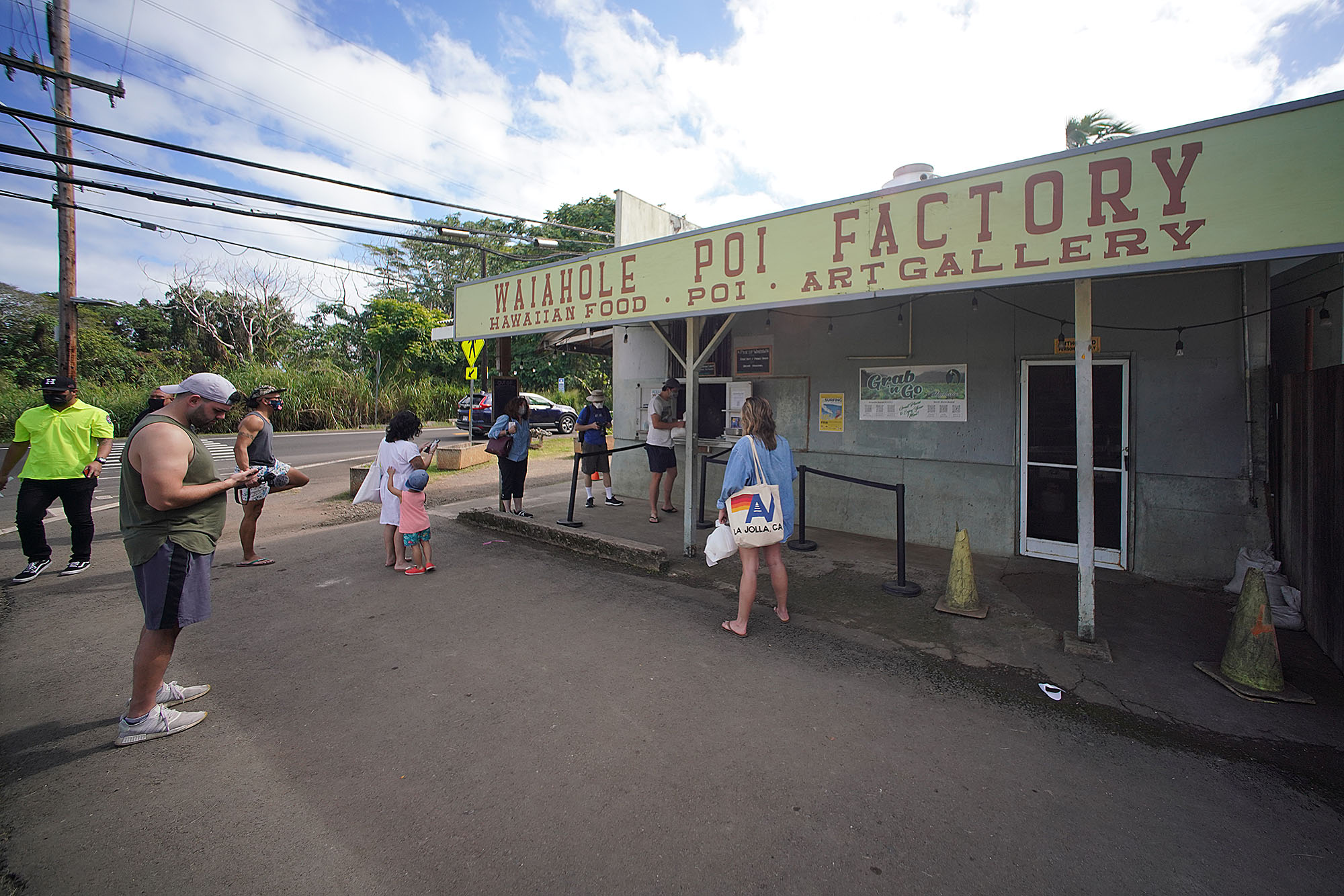 Waiahole Poi Factory customers wait for their food outside the restaurant.